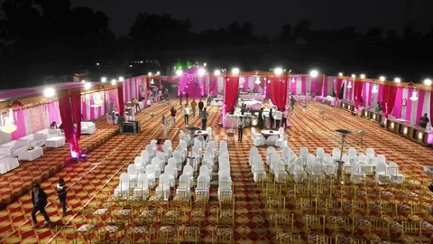 Evening reception venue with guests and lights